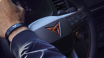 Close up view of Cupra logo and steering wheel