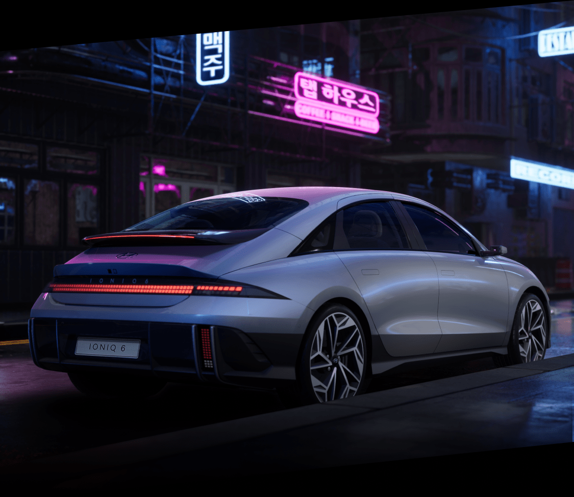 Rear view of the Ioniq 6 in neon city background