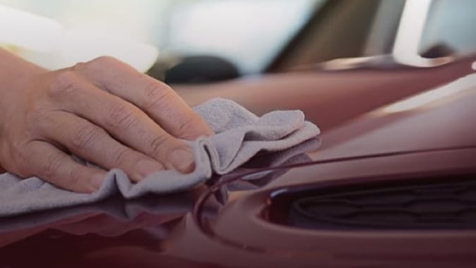 Model using cloth cleaning car